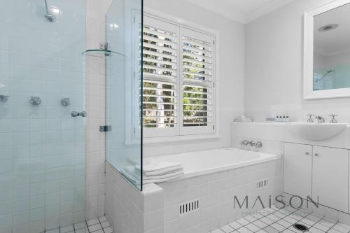 een witte badkamer met een wastafel en een douche bij Two Bedroom Villa in The Hunter Valley in Pokolbin