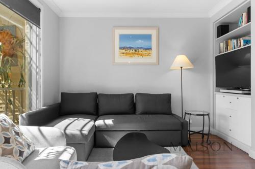 a living room with a couch and a tv at Two Bedroom Villa in The Hunter Valley in Pokolbin