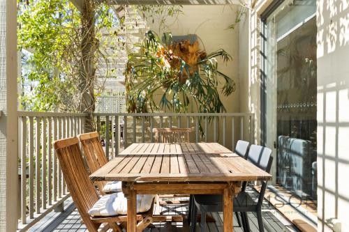 a wooden table and chairs on a porch at Two Bedroom Villa in The Hunter Valley in Pokolbin