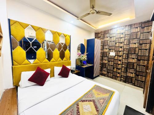 a bedroom with a bed and a wall of books at Staybook Hotel Jai Balaji, Paharganj, New Delhi Railway Station in New Delhi