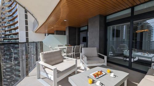 a balcony with a table and chairs on a building at SUNSET WAVES luxury apartment in Benidorm