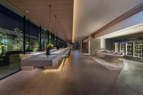 a lobby of a building with a long row of benches at Hyatt House Tokyo Shibuya in Tokyo
