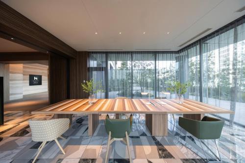 a dining room with a wooden table and chairs at Hyatt House Tokyo Shibuya in Tokyo