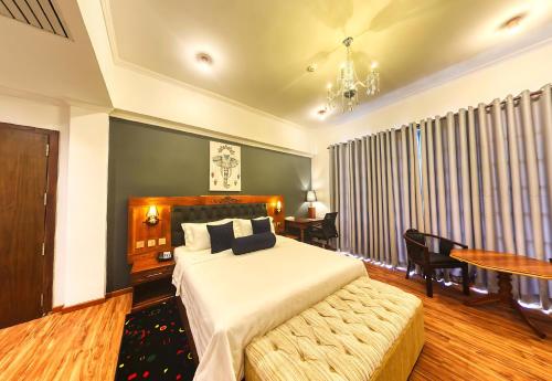 a bedroom with a bed and a table and chairs at Covanro Sigiriya - Where Heritage Meets Luxury in Sigiriya