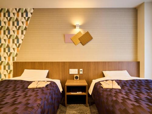 Postel nebo postele na pokoji v ubytování Kyoto Daiichi Hotel