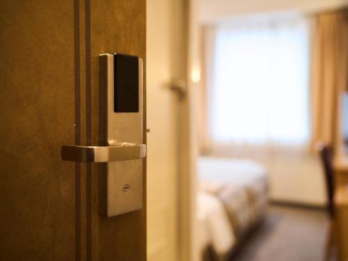 Postel nebo postele na pokoji v ubytování Kyoto Daiichi Hotel
