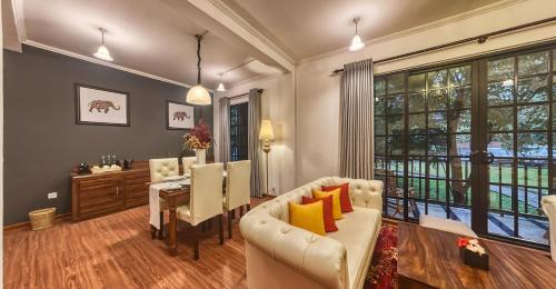 a living room with a couch and a table and chairs at Covanro Sigiriya - Where Heritage Meets Luxury in Sigiriya
