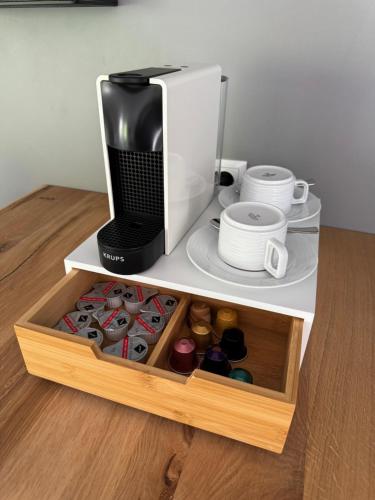 a microwave oven sitting on top of a white shelf at Cityhotel Kaiser Karl Aachen in Aachen