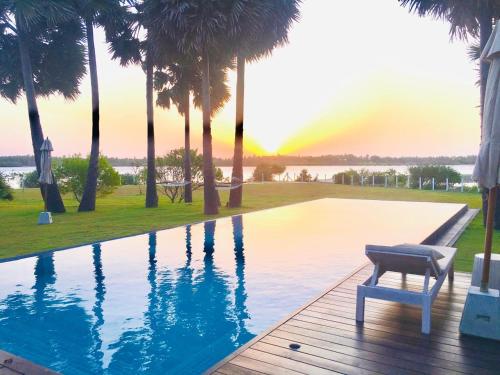 a chair sitting on a deck next to a swimming pool at Koddu Kalpitiya in Kalpitiya