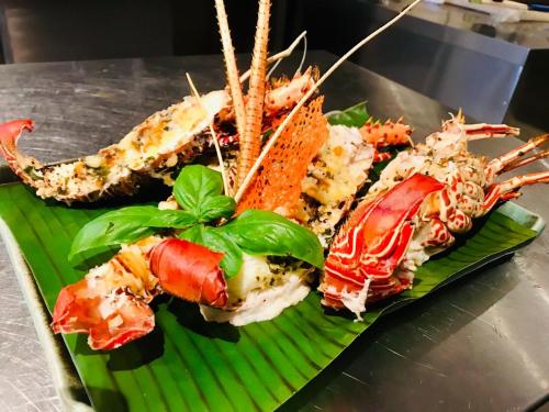 a plate of different types of seafood on a banana leaf at Koddu Kalpitiya in Kalpitiya