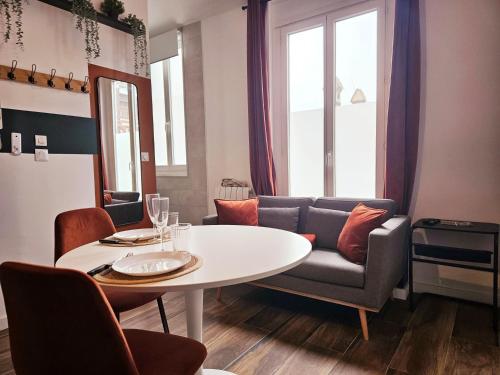 un salon avec une table et un canapé dans l'établissement Le Bain Rouennais, à Rouen