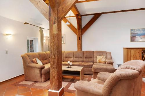 a living room with two couches and a table at Galerie Haus Wohnung 2 in Sehestedt