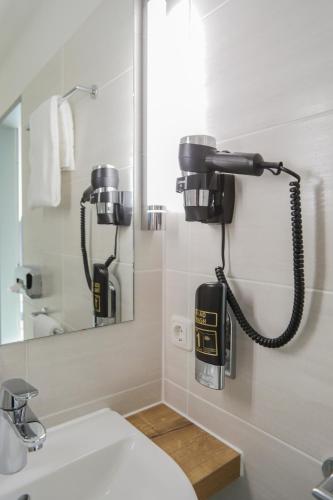 a bathroom with two cameras hanging on the wall at acama Hotel & Hostel Kreuzberg in Berlin
