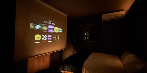 a room with a wall with a bunch of iphones at Rakuten STAY HOUSE Kujukuri Ichinomiya in Ichigaya
