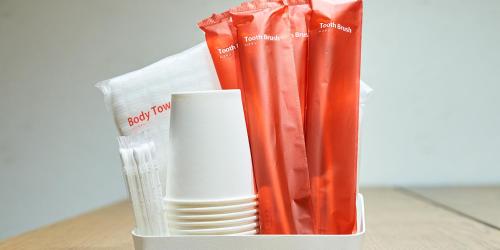 a plastic container with a stack of plates and a cup at Rakuten STAY HOUSE Kujukuri Ichinomiya in Ichigaya