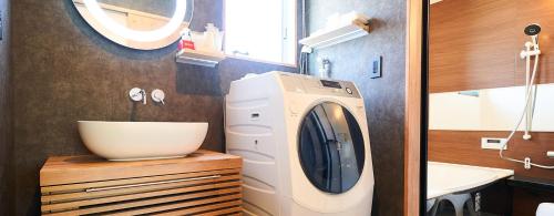 a washing machine in a bathroom with a sink at Rakuten STAY HOUSE Kujukuri Ichinomiya in Ichigaya
