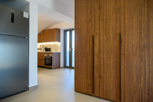 a kitchen with wooden sliding doors in a kitchen at Αntheon Apartment 3 in Agios Nikolaos