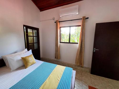 a bedroom with a bed and a window at Urban Galle Villa in Galle