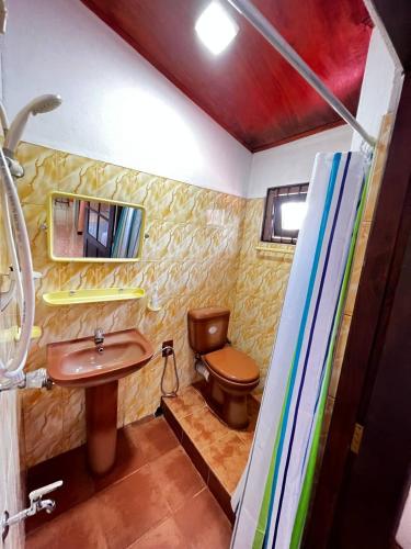 a bathroom with a toilet and a sink at Urban Galle Villa in Galle