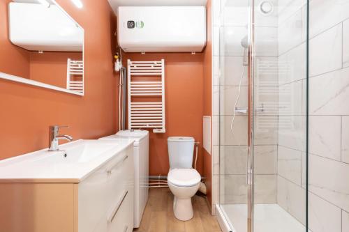 a bathroom with a toilet and a shower at Lille Vauban: apartment with parking in Lille
