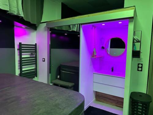 a room with a purple room with a bed at Liberty walk in Montmorot