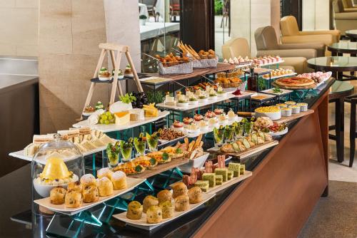 a buffet line with many different types of food at Goodwood Park Hotel in Singapore
