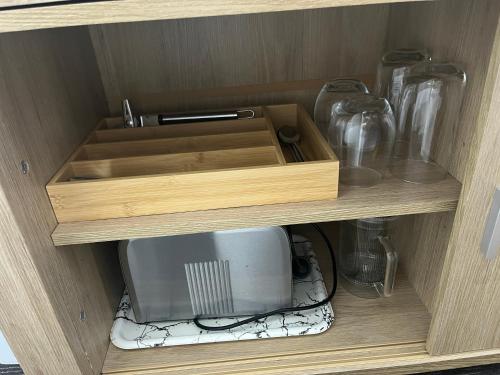 a cabinet with a sink and a microwave in it at House of Somer in Matamata