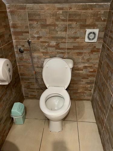 a bathroom with a white toilet in a stall at Hostel Fair and Square in Belgrade