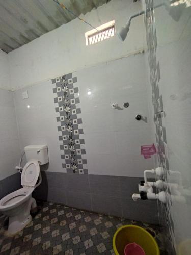 a bathroom with a shower and a toilet in it at Karthik home stay in Hampi