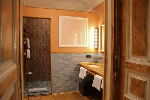 a bathroom with a sink and a shower at Brody House - boutique hotel in Budapest