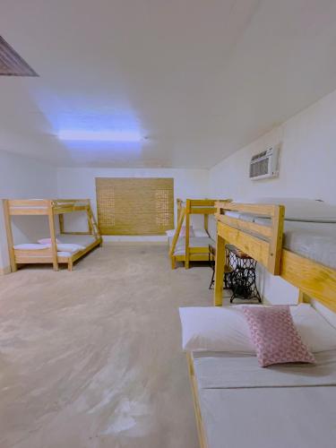 a large room with two beds and a couch at Kadilian Beach House in Currimao