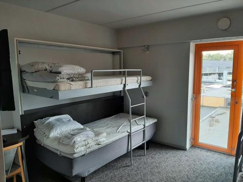 two bunk beds in a room with a window at Kolding Sportel in Kolding