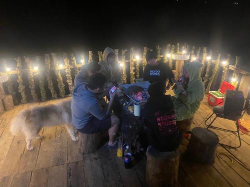 a group of people standing around a table with a dog at THIÊN HƯƠNG Homestay Măng Đen in Kon Von Kla
