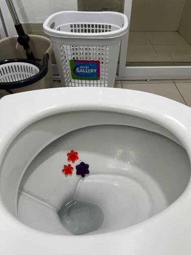 a close up of a white toilet with flowers in it at SMDC HOPE RESIDENCES (Pecho Perfect Suite) in Cavite