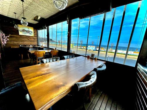Una mesa de madera en un restaurante con vistas a la playa. en Villa Siesta Hotel Istanbul Airport, en Karaburun