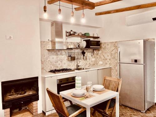 a kitchen with a table and a stove and a refrigerator at Poderino di Santa Lucia in Villa Nagliati