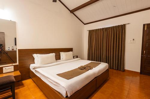 una camera con un grande letto di Scarlet Resort a Matheran
