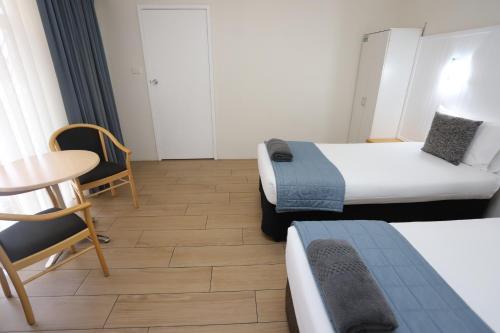 Ένα ή περισσότερα κρεβάτια σε δωμάτιο στο Sleepy Hill Motor Inn