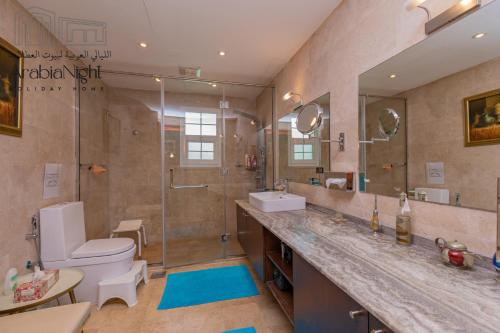a bathroom with a shower and a toilet and a sink at Arabian Nights - Exclusive Villa With Private Pool in Al Hamra Palace in Dubai