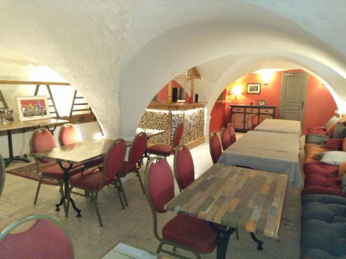 a restaurant with tables and chairs in a room at le Mas du lac - spa et détente in Monestier-dʼAmbel