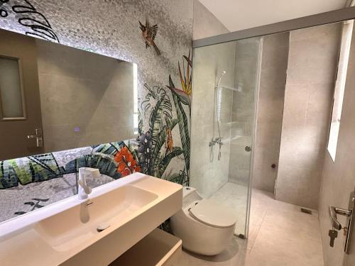 a bathroom with a sink and a shower and a toilet at 58 House - Mỹ Anh Homestay in Hai Phong