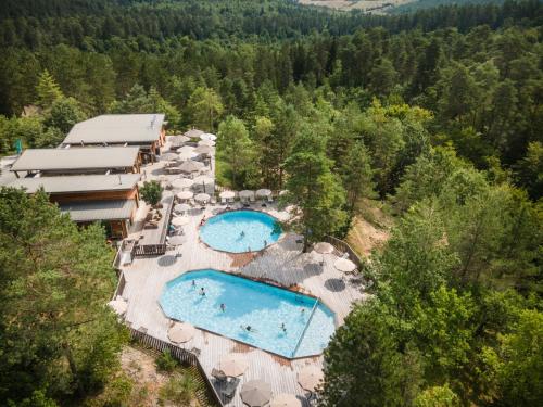 - une vue aérienne sur un complexe avec 2 piscines dans l'établissement Village Huttopia Lanmary, à Antonne-et-Trigonant