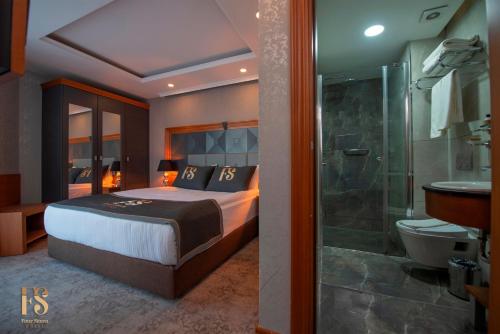 a bedroom with a bed and a bathroom with a shower at FOUR SEVEN HOTEL in Istanbul