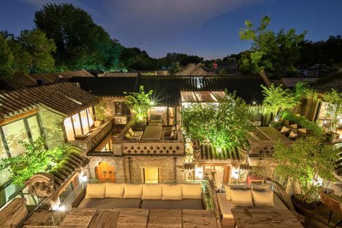 an aerial view of a house with a patio at night at Beijing Le Zai Nan Luo Gu Xiang Wang Fu Jing Forbidden City Courtyard Hotel in Beijing