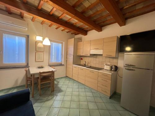 eine Küche mit einem Tisch und einem Kühlschrank in der Unterkunft vista sul corso in Iesi