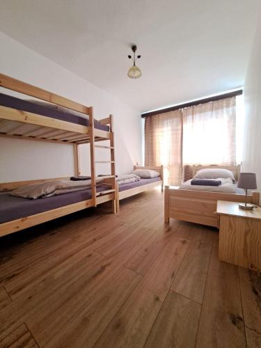 a bedroom with two bunk beds and a window at Dom horskej služby in Terchová