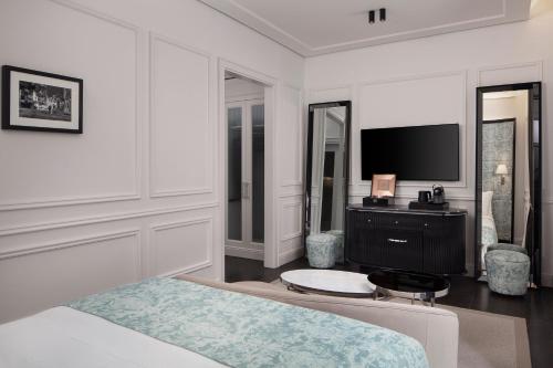 a bedroom with a bed and a flat screen tv at Sanasaryan Han, a Luxury Collection Hotel, Istanbul in Istanbul