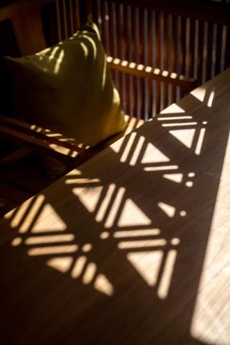 a shadow of a wooden bench with a chair at Beijing Le Zai Nan Luo Gu Xiang Wang Fu Jing Forbidden City Courtyard Hotel&Free laundry service&Free coffee &Paid Dumpling experience service in Beijing