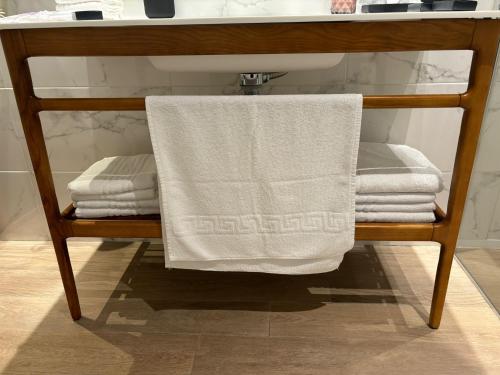 a towel on a towel rack under a bathroom sink at Apartamentos Turísticos La Plaza in Chipiona