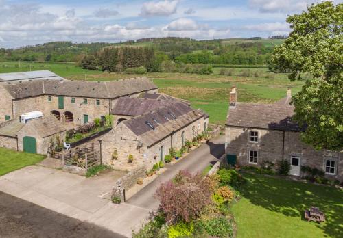 an aerial view of an old stone house at Wydon Farm Bed and Breakfast in Haltwhistle